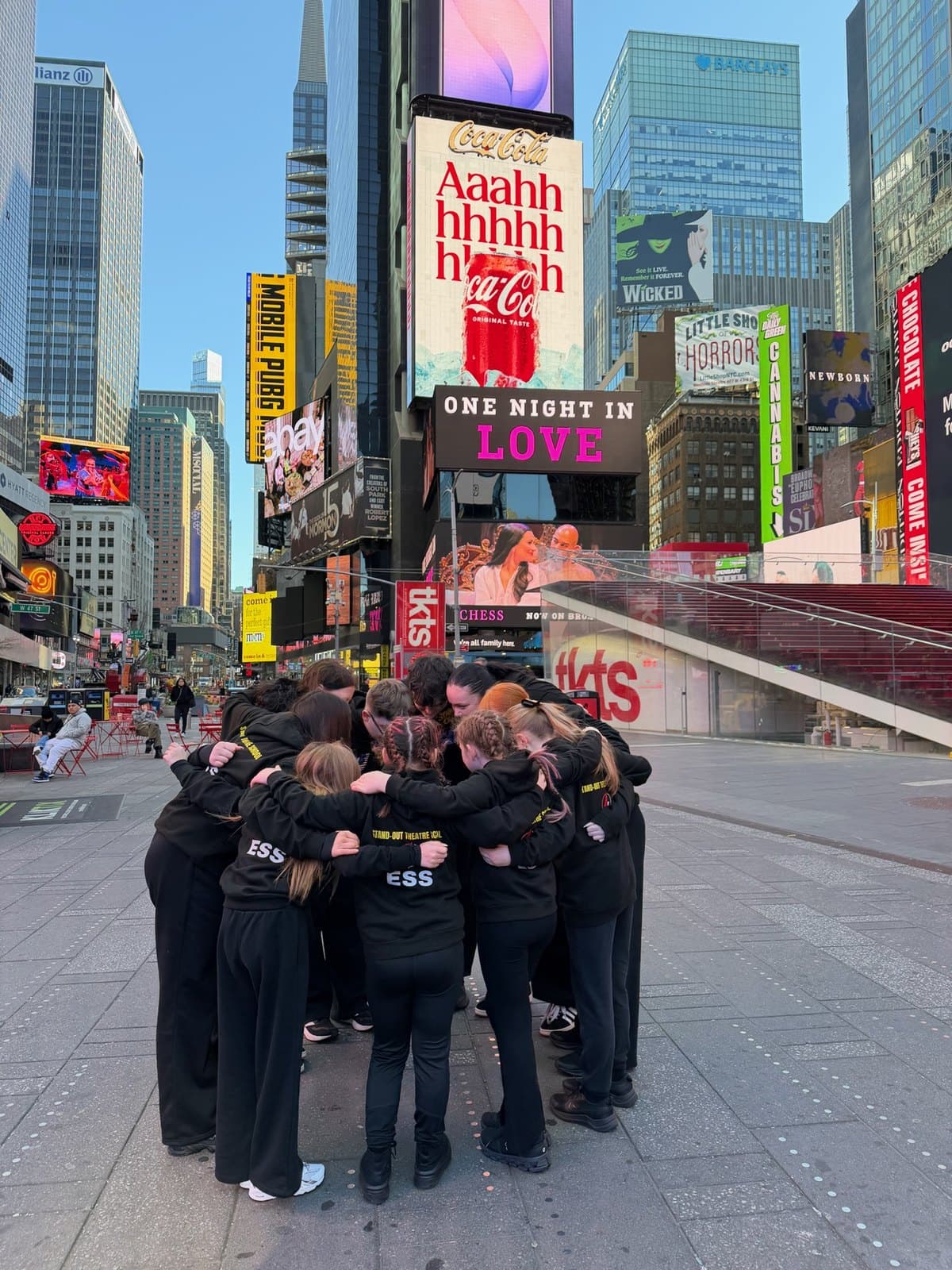Stand-Out students in a huddle in Times Square, New York
